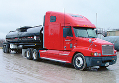 Big red truck carrying casing filling